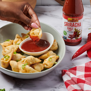 An air fryer crab rangoons recipe with Lee Kum Kee Sriracha for dipping.
