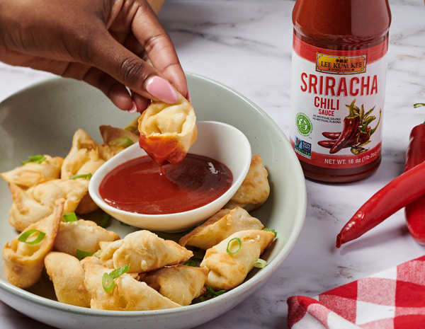 An air fryer crab rangoons recipe with Lee Kum Kee Sriracha for dipping.