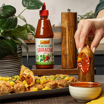 An al pastor egg rolls recipe filled with an al pastor style ground pork, Oaxaca cheese, and served with cilantro lime sriracha for dipping.