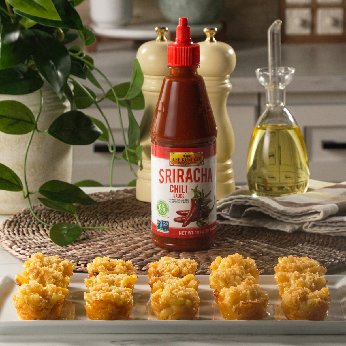 A baked mac and cheese bites recipe topped with Lee Kum Kee Sriracha.