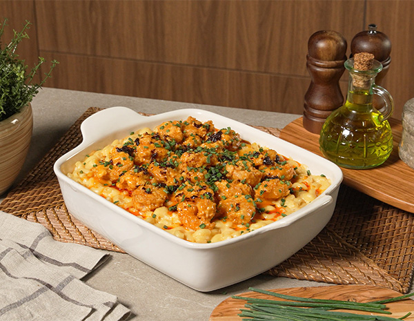 A bang bang shrimp recipe served on top of mac and cheese.