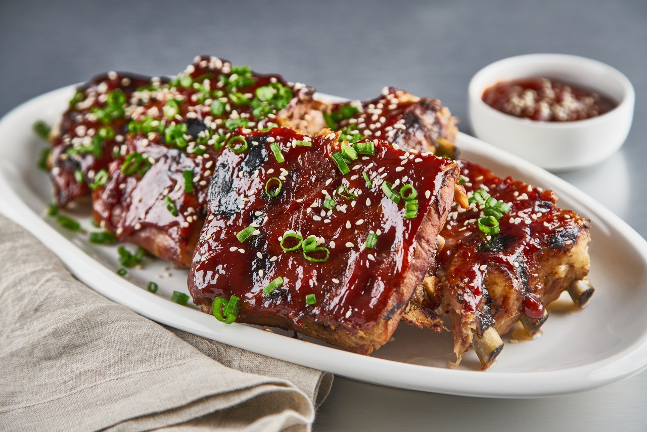 A barbecue pork ribs recipe with hoisin sauce topped with sesame seeds.