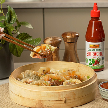 A dumplings recipe filled with birria meat and consommé broth, served with cilantro lime sriracha.