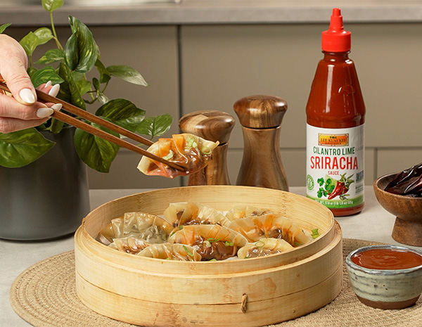 A dumplings recipe filled with birria meat and consommé broth, served with cilantro lime sriracha.