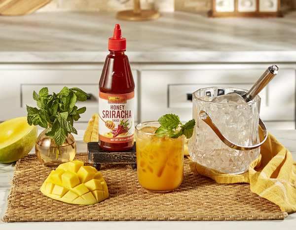 A bourbon smash cocktail recipe made with Lee Kum Kee Honey Sriracha.