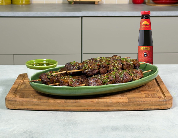 A churrasco skewers recipe, marinated in oyster sauce, served with a chimichurri sauce