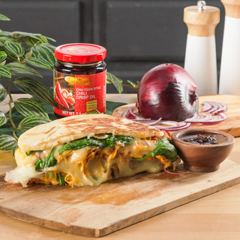 A butter chicken panini recipe featuring Lee Kum Kee chili crisp oil.