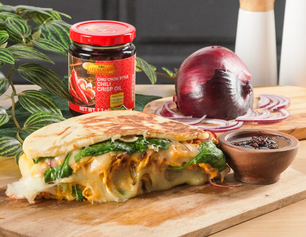 A butter chicken panini recipe featuring Lee Kum Kee chili crisp oil.
