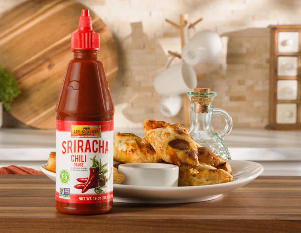 A recipe of Cajun Sausage Puffs with a side of spicy mustard, made with Lee Kum Kee Sriracha Chili Sauce.