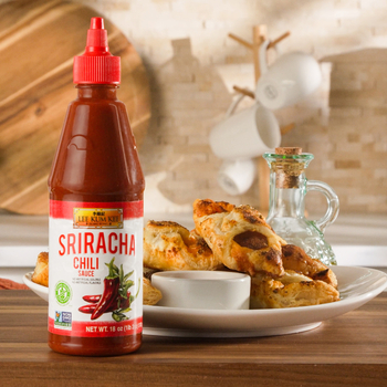 A plate of Cajun Sausage Puffs with a side of spicy mustard, made with Lee Kum Kee Sriracha Chili Sauce.