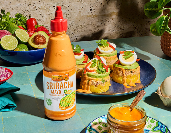 A Peruvian recipe for Causa de Mariscos made with Sriracha Mayo.