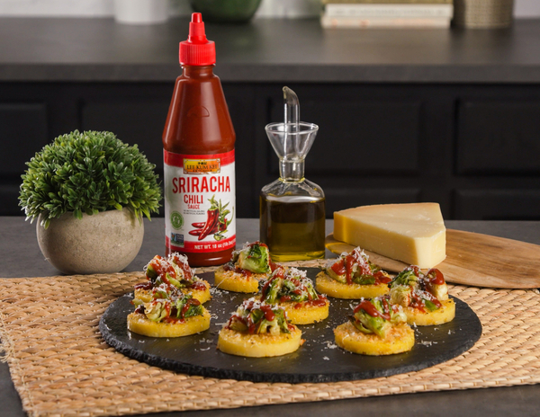 Cheesy Polenta Bites recipe topped with spicy brussels sprouts, made with Lee Kum Kee Sriracha Chili Sauce for heat.