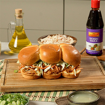 An easy chicken sliders recipe with a smoky hoisin bbq sauce, slaw, and Sriracha mayo.