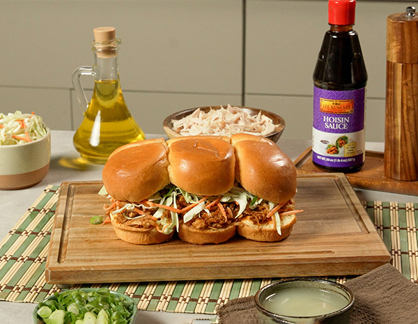 An easy chicken sliders recipe with a smoky hoisin bbq sauce, slaw, and Sriracha mayo.