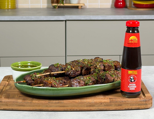 A churrasco skewers recipe, marinated in oyster sauce, served with a chimichurri sauce