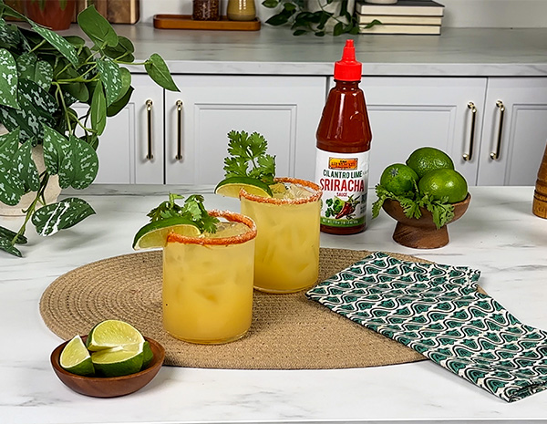 A mocktail recipe for a cilantro lime margarita, made with a cilantro lime sriracha rim.