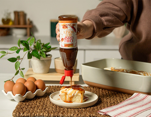 A cinnamon rolls recipe finished with chili crisp hot honey for a sweet and spicy twist.