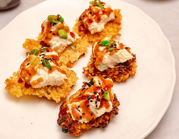 A crispy rice recipe topped with a crab rangoon mix.