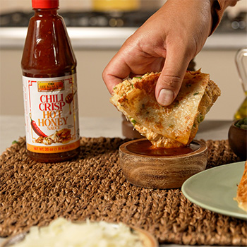 A crab rangoon quesadilla recipe made with scallion pancakes and served with chili crisp hot honey for dipping.