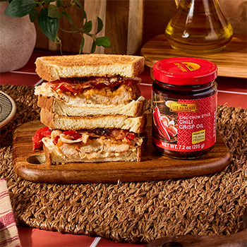 A crispy chicken cutlet sandwich recipe topped with Lee Kum Kee Chiu Chow Style Chili Crisp Oil.