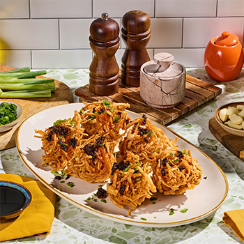 Crispy shrimp balls, an iconic dim sum recipe, dressed with chili crisp oil.