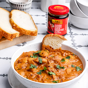 An easy spicy and creamy butter beans recipe made with Lee Kum Kee Chili crisp oil.