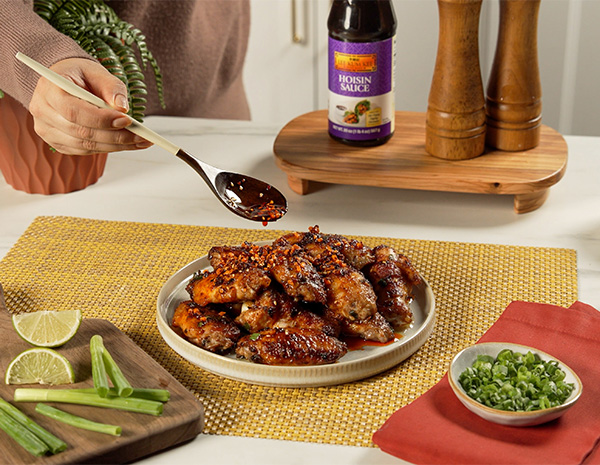 A fish sauce wings recipe made with a hoisin and fish sauce marinade, a garlic butter sauce, and a drizzle of chili crisp.
