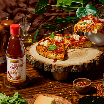 A focaccia pizza recipe drizzled with chili crisp hot honey.