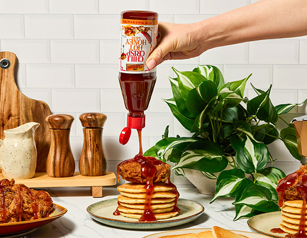 A brunch recipe featuring fried chicken and fluffy pancakes with chili crisp hot honey.