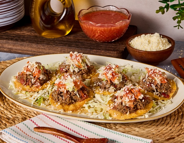 A Garnachas recipe for a Guatemalan street food favorite topped with beef.