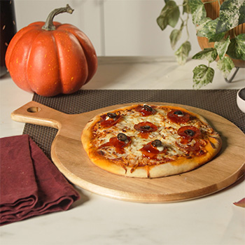 A spicy Halloween pizza recipe with spooky cheese and olive "eyeballs".