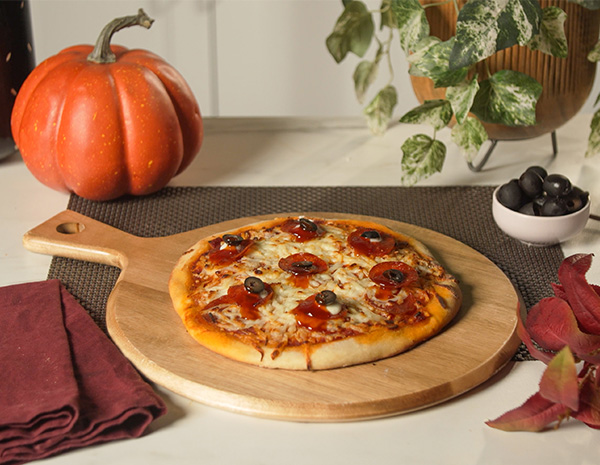 A spicy Halloween pizza recipe with spooky cheese and olive "eyeballs".