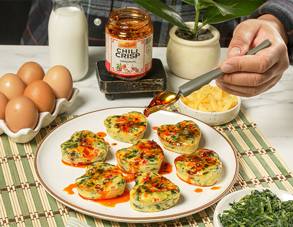 A heart shaped egg bites recipe topped with Chili Crisp for a Mother's Day brunch.