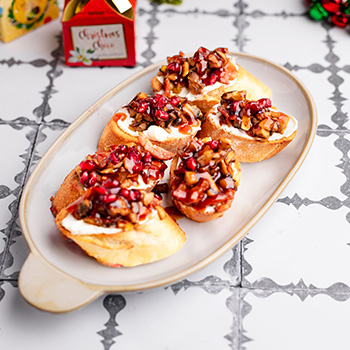 A holiday crostini recipe made with a hot honey bacon jam.