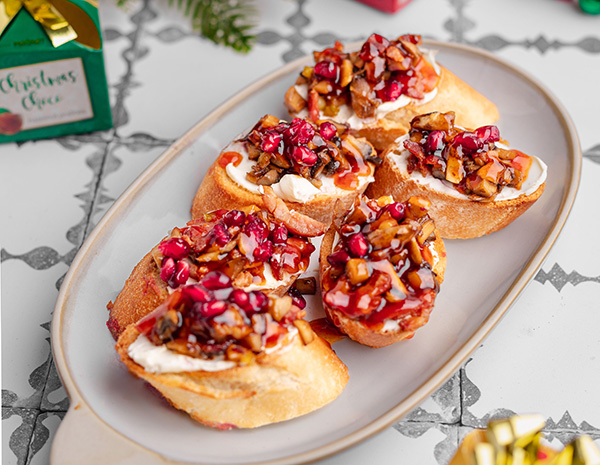 A holiday crostini recipe made with a hot honey bacon jam.