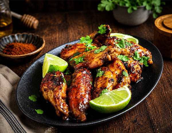 A Honey Sriracha Chicken wings recipe with a sweet, savory, and spicy hot honey glaze.
