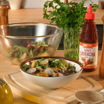 A roasted potato salad recipe with Lee Kum Kee Honey Sriracha dressing.