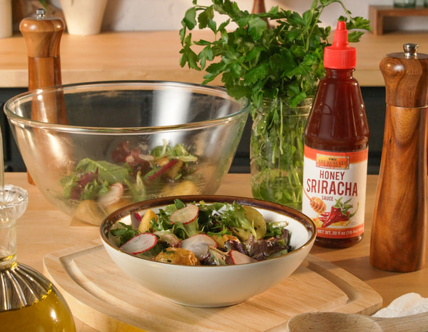 A roasted potato salad recipe with Lee Kum Kee Honey Sriracha dressing.