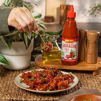 A Korean fried chicken nuggets recipe tossed in a spicy soy glaze made with Lee Kum Kee Sriracha Chili Sauce.