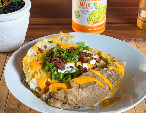 A loaded baked potato recipe made in the microwave with Lee Kum Kee Sriracha Mayo.