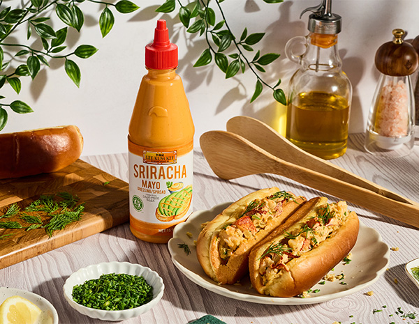 A lobster roll recipe made with a dill pickle remoulade, using a base of Sriracha Mayo.