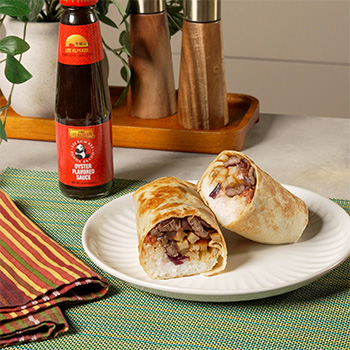 A lomo saltado burrito, filled with Peruvian lomo saltado.