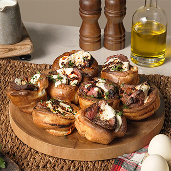 A mini yorkshire pudding platter loaded with roast beef.