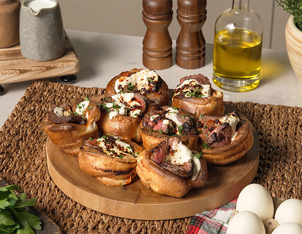 A mini yorkshire pudding platter loaded with roast beef.