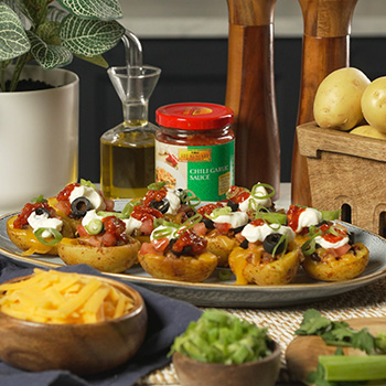 A loaded potato skins recipe with nacho flavors and Lee Kum Kee chili garlic sauce.