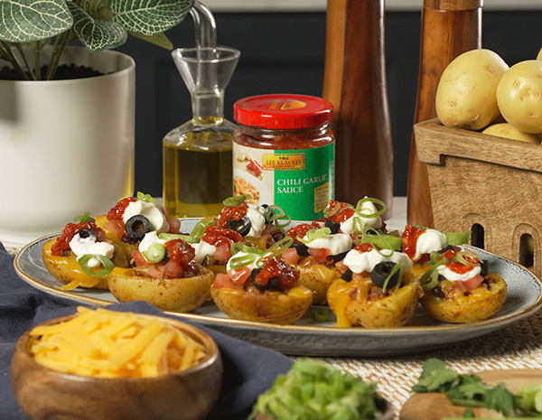 A loaded potato skins recipe with nacho flavors and Lee Kum Kee chili garlic sauce.