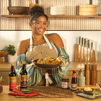 A Filipino pancit noodles recipe created by Chef Tiana Gee and topped with a fried egg.