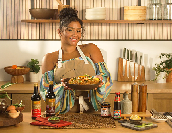 A Filipino pancit noodles recipe created by Chef Tiana Gee and topped with a fried egg.