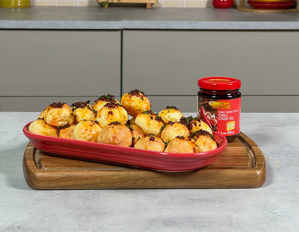 A pao de queijo recipe for Brazilian cheese bread topped with chili crisp oil.