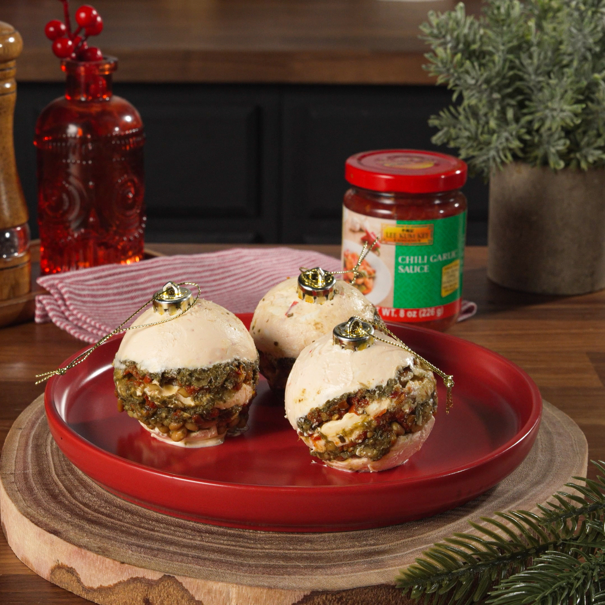 A pesto cheese ball ornament recipe for Christmas made with Lee Kum Kee Chili Garlic Sauce.